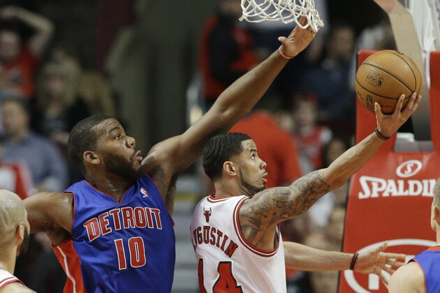 Chicago Bulls guard D.J. Augustin, right, shoots against Detroit Pistons forward Greg Monroe during the first half of an NBA basketball game in Chicago on Friday, April 11, 2014. (AP Photo/Nam Y. Huh)