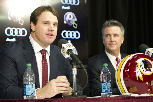 Jan 9, 2014; Ashburn, VA, USA; Washington Redskins head coach Jay Gruden speaks as general manager Bruce Allen looks on during a press conferences at Redskins Park Team Auditorium. Mandatory Credit: Brad Mills-USA TODAY Sports
