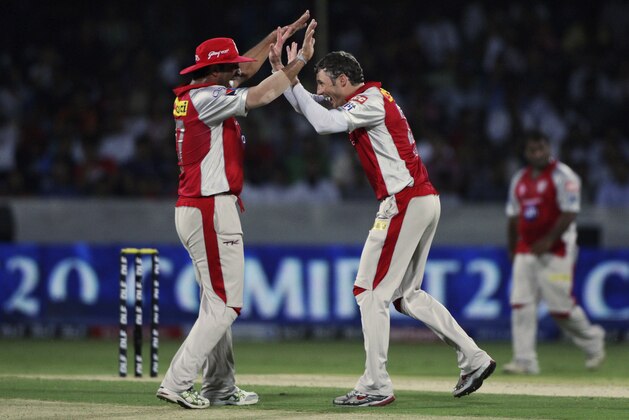Kings XI Punjab bowler David Hussey, right, with Azhar Mahmood, celebrates the wicket of Deccan Chargers Daniel Harris during their Indian Premier League (IPL) cricket match in Hyderabad, India, Tuesday, May 8, 2012. (AP Photo/Mahesh Kumar A.)
