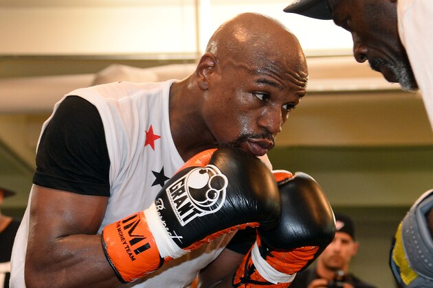 LAS VEGAS, NV - APRIL 22:  Boxer Floyd Mayweather Jr. works out with his trainer and uncle Roger Mayweather at the Mayweather Boxing Club on April 22, 2014 in Las Vegas, Nevada. Mayweather will face Marcos Maidana in a 12-round world championship unification bout in Las Vegas on May 3.  (Photo by Ethan Miller/Getty Images)