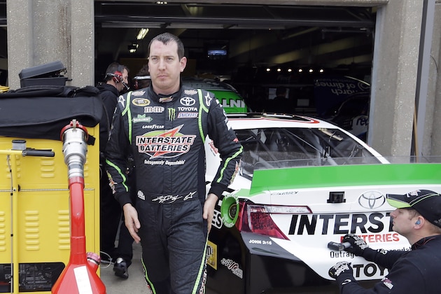 Kyle Busch leaves the garage heading to his trailer after a practice session for the NASCAR Sprint Cup Series auto race at Texas Motor Speedway in Fort Worth, Texas, Saturday, April 5, 2014. (AP Photo/LM Otero)
