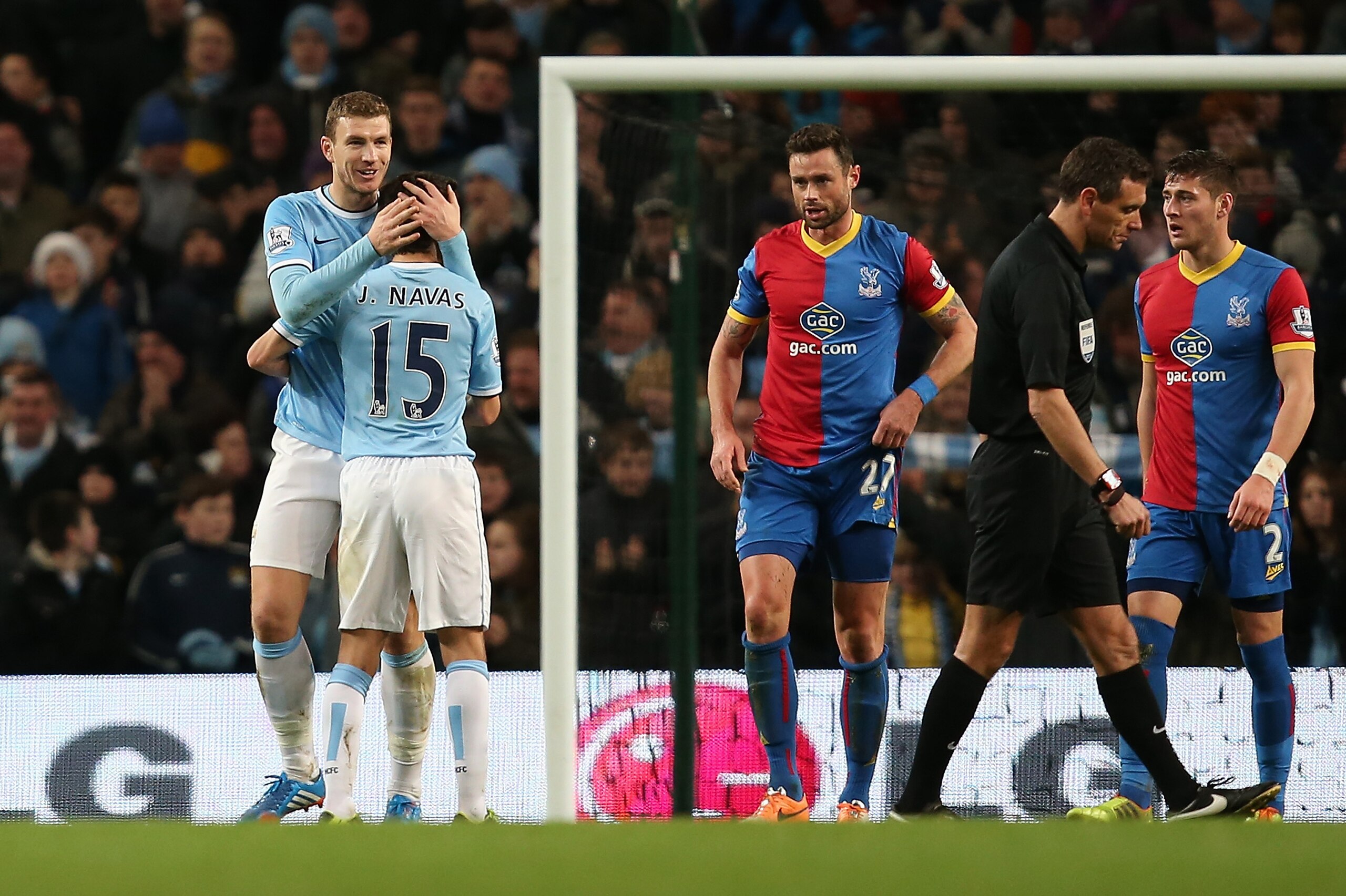 MANCHESTER, ENGLAND - DECEMBER 28:  Edin Dzeko of Manchester City is congratulated by team-mate Jesus Navas after scoring the opening goal during the Barclays Premier League match between Manchester City and Crystal Palace at the Etihad Stadium on December 28, 2013 in Manchester, England.  (Photo by Jan Kruger/Getty Images)