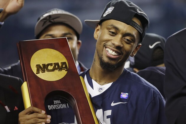 Connecticut guard Ryan Boatright holds the championship trophy after his team beat Kentucky 60-54, at the NCAA Final Four tournament college basketball championship game Monday, April 7, 2014, in Arlington, Texas. (AP Photo/David J. Phillip)