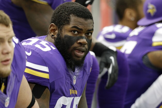 Minnesota Vikings defensive tackle Sharrif Floyd (95) watches from the bench during the first half of an NFL football game against the Detroit Lions, Sunday, Dec. 29, 2013, in Minneapolis. (AP Photo/Ann Heisenfelt)