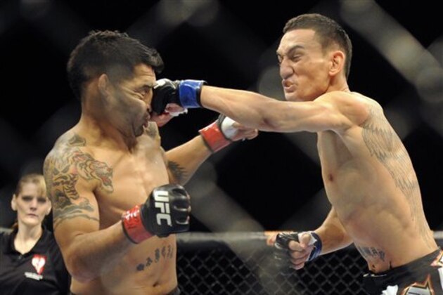 Max Holloway punches Leonard Garcia in the face during their UFC 155 featherweight bout at the MGM Grand Garden Arena Saturday, Dec, 29, 2012 in Las Vegas. Holloway won the mixed martial arts match by a split decision. (AP Photo/David Becker)