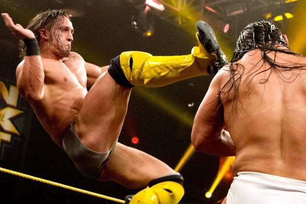 Adrian Neville kicks Bo Dallas.
