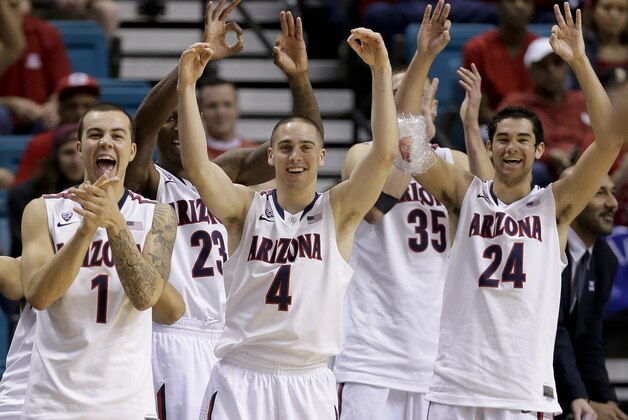 Arizona players, including Gabe York (1), T.J. McConnell (4) and Elliott Pitts (24), react to a 3-point basket late in the second half of an NCAA college basketball game against Utah in the quarterfinals of the Pac-12 Conference tournament, Thursday, March 13, 2014, in Las Vegas. Arizona won 71-39. (AP Photo/Julie Jacobson)