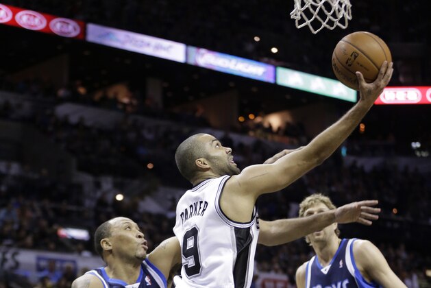 San Antonio Spurs' Tony Parker (9), of France, shoots around Dallas Mavericks' Shawn Marion, left, and Dirk Nowitzki (41), of Germany, during the first half of Game 2 of the opening-round NBA basketball playoff series on Wednesday, April 23, 2014, in San Antonio.  (AP Photo/Eric Gay)