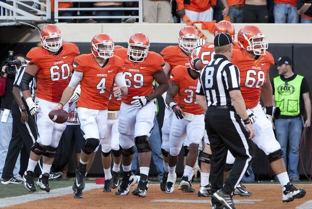 Nov 17, 2012; Stillwater OK, USA; Oklahoma State Cowboys cornerback Justin Gilbert (4) celebrates after a touchdown during the second quarter against the Texas Tech Red Raiders at Boone Pickens Stadium.  Mandatory Credit: Richard Rowe-USA TODAY Sports