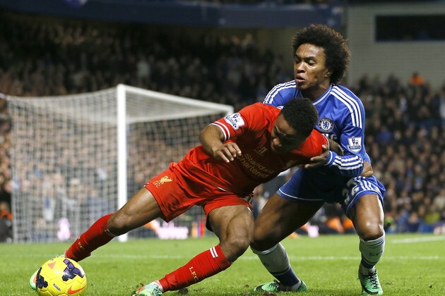 Chelsea's Willian, right, vies for the ball with Liverpool's Raheem Sterling during the English Premier League soccer match between Chelsea and Liverpool at Stamford Bridge Stadium in London, Sunday, Dec. 29, 2013. (AP Photo/Kirsty Wigglesworth)