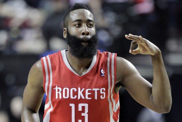 Houston Rockets guard James Harden flashes three fingers after scoring a three point shot during the second half of Game 3 of an NBA basketball first-round playoff series against the Portland Trail Blazers in Portland, Ore., Friday, April 25, 2014. Harden scored 37 points as the Rockets won 121-116. (AP Photo/Don Ryan)