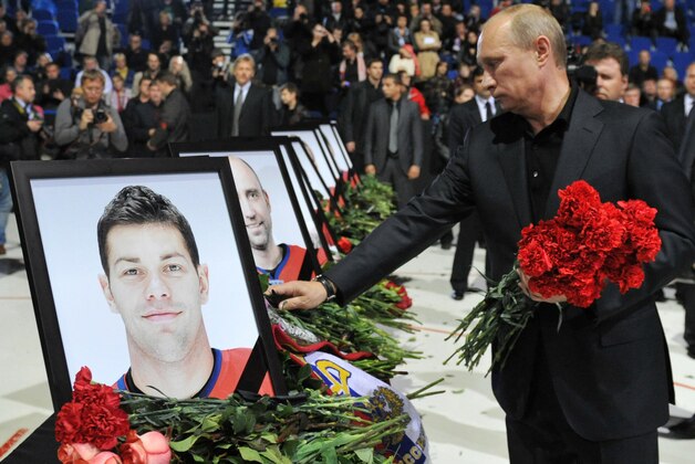 Russian Prime Minister Vladimir Putin lays flowers during a memorial ceremony for the victims of the Russian plane crash in the Arena in Yaroslavl, 150 miles (240 kilometers) northeast of Moscow in Russia, Saturday, Sept. 10, 2011. The chartered Yak-42 jet crashed Wednesday into the banks of the Volga River moments after takeoff from an airport near Yaroslavl. The crash killed 43 people, including 36 players, coaches and staff of the Lokomotiv Yaroslavl ice hockey team, many of whom were European national team and former NHL players. (AP Photo/RIA Novosti, Alexei Nikolsky, Pool)