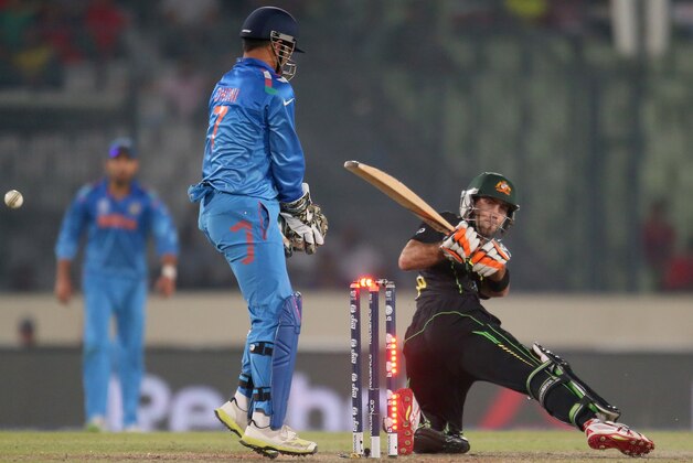 DHAKA, BANGLADESH - MARCH 30:  Glenn Maxwell of Australia is out bowled as MS Dhoni of India looks on during the ICC World Twenty20 Bangladesh 2014 match between India v Australia at Sher-e-Bangla Mirpur Stadium on March 30, 2014 in Dhaka, Bangladesh.  (Photo by Scott Barbour/Getty Images)