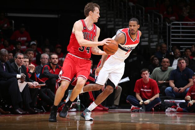 WASHINGTON, DC - APRIL 25: Mike Dunleavy #34 of the Chicago Bulls dribbles the ball in Game Three of the Eastern Conference Quarterfinals during the 2014 NBA Playoffs against Trevor Ariza #1 of the Washington Wizards at the Verizon Center on April 25, 2014 in Washington, DC. NOTE TO USER: User expressly acknowledges and agrees that, by downloading and or using this photograph, User is consenting to the terms and conditions of the Getty Images License Agreement. (Photo by Ned Dishman/Getty Images)