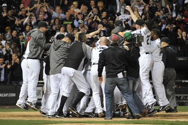 Chicago White Sox's Jose Abreu, right, celebrates with teammates after hitting a grand slam against theTampa Bay Rays during the ninth inning of a baseball game in Chicago on Friday, April 25, 2014. The White Sox won 9-6. (AP Photo/Nam Y. Huh)