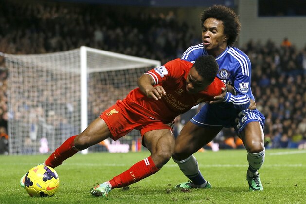 Chelsea's Willian, right, vies for the ball with Liverpool's Raheem Sterling during the English Premier League soccer match between Chelsea and Liverpool at Stamford Bridge Stadium in London, Sunday, Dec. 29, 2013. (AP Photo/Kirsty Wigglesworth)
