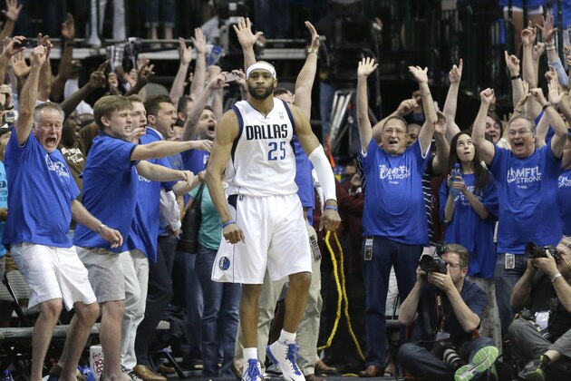 Fans cheer as Dallas Mavericks guard Vince Carter stands in the corner after he made the game-winning 3-point basket at the buzzer in the fourth quarter against the San Antonia Spurs in Game 3 in the first round of the NBA basketball playoffs in Dallas, Saturday, April 26, 2014.  The Mavericks won 109-108. (AP Photo/LM Otero)