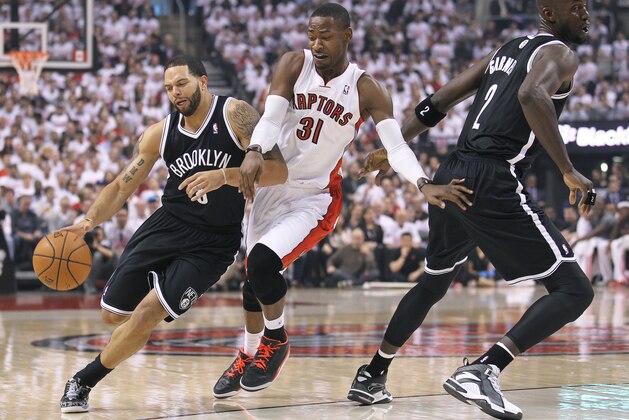TORONTO, ON - APRIL 19:  Deron Williams #8 of the Brooklyn Nets drives around Terrence Ross #31 of the Toronto Raptors in Game One of the NBA Eastern Conference play-off at the Air Canada Centre on April 19, 2014 in Toronto, Ontario, Canada. The Nets defeated the Raptors 94-87 to take a 1-0 series lead. NOTE TO USER: user expressly acknowledges and agrees that, by downloading and/or using this Photograph, user is consenting to the terms and conditions of the Getty Images License Agreement. (Photo by Claus Andersen/Getty Images)