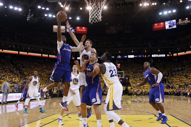 Los Angeles Clippers' Chris Paul, left, goes up for a layup past Golden State Warriors' David Lee (10), teammate Blake Griffin (32) and the Warriors' Draymond Green (23) during the second half in Game 3 of an opening-round NBA basketball playoff series on Thursday, April 24, 2014, in Oakland, Calif. Los Angeles won 98-96. (AP Photo/Marcio Jose Sanchez)