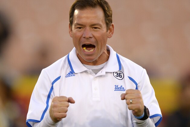 UCLA head coach Jim Mora cheers his team on during warmups prior to an NCAA college football game against Southern California, Saturday, Nov. 30, 2013, in Los Angeles. (AP Photo/Mark J. Terrill)