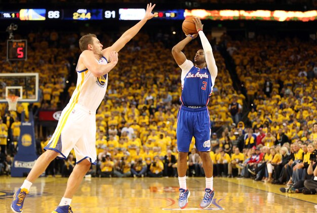 Apr 24, 2014; Oakland, CA, USA; Los Angeles Clippers guard Chris Paul (3) scores a three point basket against Golden State Warriors forward David Lee (10) during the fourth quarter of game three of the first round of the 2014 NBA Playoffs at Oracle Arena. The Los Angeles Clippers defeated the Golden State Warriors 98-96. Mandatory Credit: Kelley L Cox-USA TODAY Sports