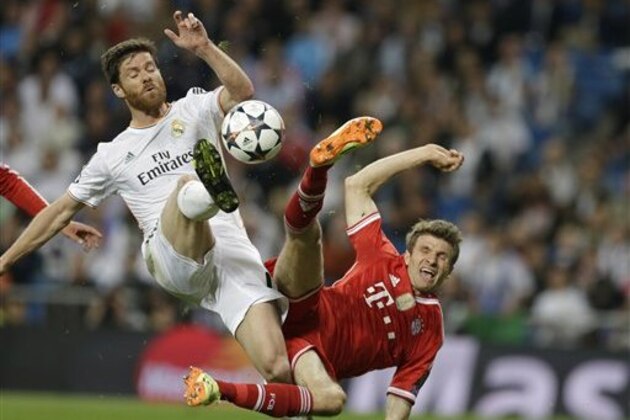 Real's Xabi Alonso, left, and Bayern's Thomas Mueller challenge for the ball during a Champions League semifinal first leg soccer match between Real Madrid and Bayern Munich at the Santiago Bernabeu stadium in Madrid, Spain, Wednesday, April 23, 2014 .(AP Photo/Paul White) Real's Xabi Alonso, left, and Bayern's Thomas Mueller challenge for the ball during a Champions League semifinal first leg soccer match between Real Madrid and Bayern Munich at the Santiago Bernabeu stadium in Madrid, Spain, Wednesday, April 23, 2014 .(AP Photo/Paul White)