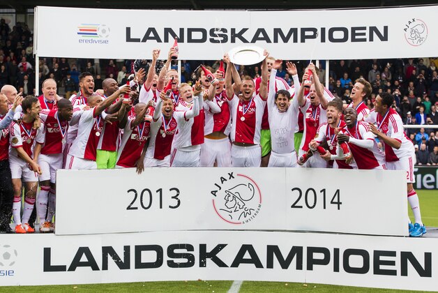 Ajax soccer players celebrate with the trophy after defeating Heracles Almelo in the Dutch Premier League final with a 1-0 score in Almelo, Netherlands, Sunday April 27, 2014. (AP Photo/Vincent Jannink)