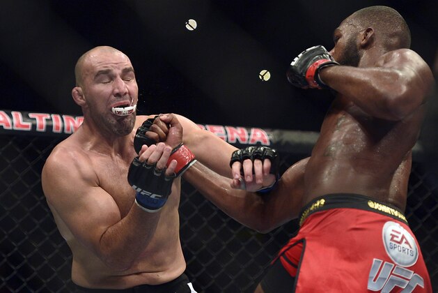 Apr 26, 2014; Baltimore, MD, USA;  Jon Jones hits  Glover Teixeira with an upper cut during the UFC light heavy weight championship fight at  Baltimore Arena. Jones retained the light heavy height championship by defeating  Teixeria.  Mandatory Credit: Tommy Gilligan-USA TODAY Sports