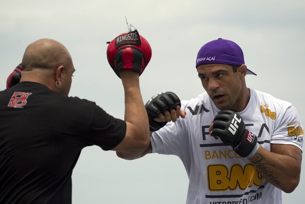Vitor Belfort, of Brazil, right, trains during UFC Rio Open Workouts on Barra de Tijuca Beach in Rio de Janeiro, Brazil, Wednesday Jan. 11, 2012.  Belfort will face Anthony Johnson, of the U.S., on Jan. 14 at the Ultimate Fighting Championship's UFC 142, the organization's second event in Rio de Janeiro.  (AP Photo/Felipe Dana)