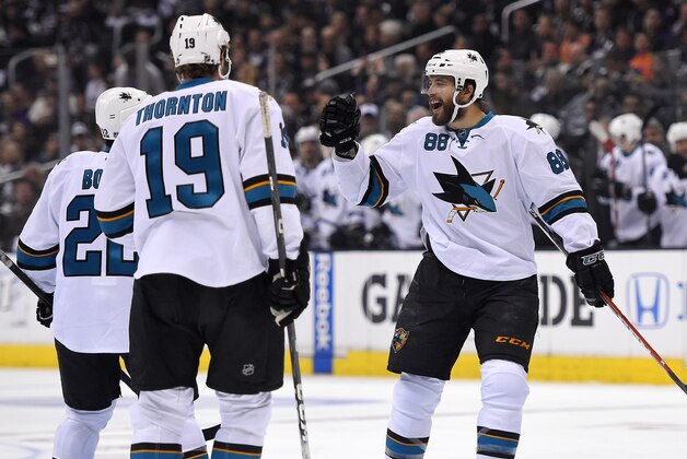 San Jose Sharks right wing Brent Burns, right, celebrates his goal with teammates defenseman Dan Boyle, left, and center Joe Thornton during the first period in Game 3 of an NHL hockey first-round playoff series , Tuesday, April 22, 2014, in Los Angeles. (AP Photo/Mark J. Terrill)