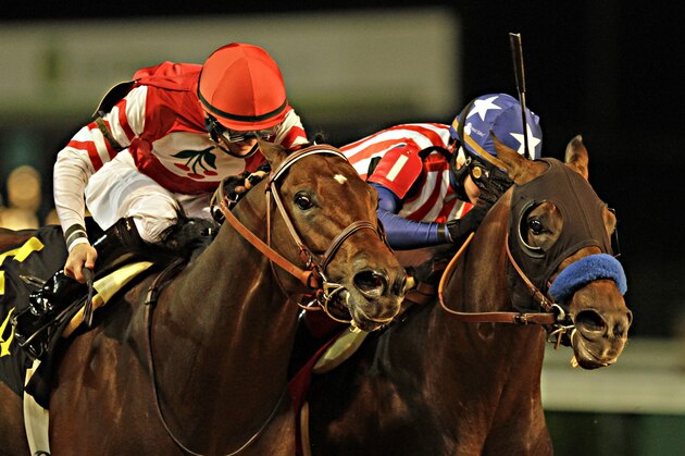 Bayern, right, ridden by Rosie Napravnik, battles Embellishing Bob, left, ridden by Brian Hernandez Jr., at the wire in Derby Trial horse race at Churchill Downs in Louisville, Ky., Saturday, April 26, 2014. Bayern finished first, but was disqualified and placed second for interference in the stretch and Embellishing Bob was awarded the victory. (AP Photo/Garry Jones)