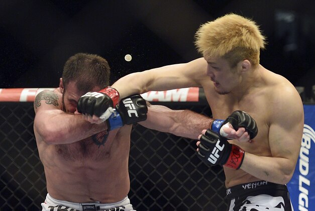 Apr 26, 2014; Baltimore, MD, USA;  Takanori Gomi (right) lands a punch on  Issac Vallie-Flagg during the first round in UFC 172 at Baltimore Arena. Gomi  defeated Wallie-Flagg by judges decision.  Mandatory Credit: Tommy Gilligan-USA TODAY Sports