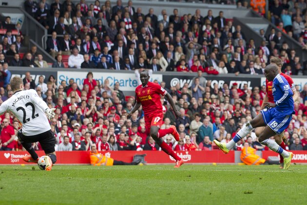 Chelsea's Demba Ba, right, scores against Liverpool during their English Premier League soccer match at Anfield Stadium, Liverpool, England, Sunday April 27, 2014. (AP Photo/Jon Super)