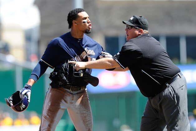 PITTSBURGH, PA - APRIL 20:  Carlos Gomez #27 of the Milwaukee Brewers is restrained by Homeplate Umpire Fieldin Culbreth during the third inning against the Pittsburgh Pirates on April 20, 2014 at PNC Park in Pittsburgh, Pennsylvania.  (Photo by Joe Sargent/Getty Images)