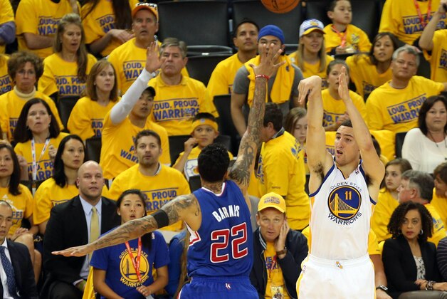 Apr 27, 2014; Oakland, CA, USA; Golden State Warriors guard Klay Thompson (11) scores a three point basket against Los Angeles Clippers forward Matt Barnes (22) during the second quarter of game four of the first round of the 2014 NBA Playoffs at Oracle Arena. Mandatory Credit: Kelley L Cox-USA TODAY Sports