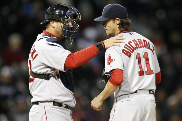 Boston Red Sox catcher A.J. Pierzynski, left, talks with starting pitcher Clay Buchholz during the sixth inning of a baseball game against the Chicago White Sox Wednesday, April 16, 2014, in Chicago. (AP Photo/Charles Rex Arbogast)