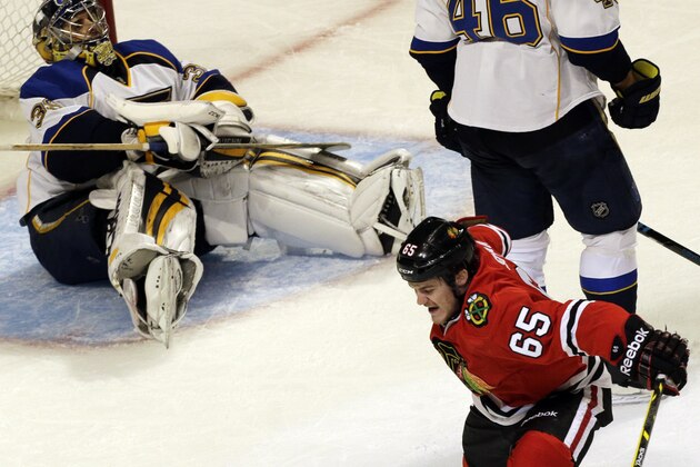 Chicago Blackhawks' Andrew Shaw (65) celebrates after scoring his goal as St. Louis Blues goalie Ryan Miller (39) reacts during the third period in Game 6 of a first-round NHL hockey playoff series in Chicago, Sunday, April 27, 2014. The Blackhawks won 5-1.(AP Photo/Nam Y. Huh)