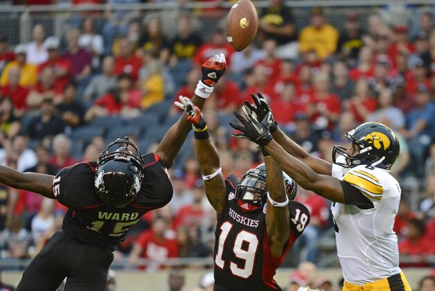 Sep 01, 2012; Chicago, IL, USA; Northern Illinois Huskies defensive back Jimmie Ward (15) and cornerback Demetrius Stone (19) break up a pass against Iowa Hawkeyes wide receiver Keenan Davis (6) during the second half at Soldier Field. Iowa defeats Northern Illinois 18-17. Mandatory Credit: Mike DiNovo-USA TODAY Sports