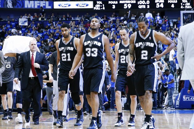 Apr 26, 2014; Dallas, TX, USA; San Antonio Spurs forward Tim Duncan (21) and forward Boris Diaw (33) and guard Manu Ginobili (20) and forward Kawhi Leonard (2) react after the second quarter against the Dallas Mavericks in game three of the first round of the 2014 NBA Playoffs at American Airlines Center. Mandatory Credit: Kevin Jairaj-USA TODAY Sports