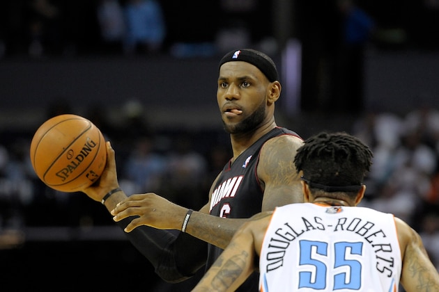 CHARLOTTE, NC - APRIL 26:  Chris Douglas-Roberts #55 of the Charlotte Bobcats defends LeBron James #6 of the Miami Heat in Game Three of the Eastern Conference Quarterfinals during the 2014 NBA Playoffs at Time Warner Cable Arena on April 26, 2014 in Charlotte, North Carolina. The Heat won 98-85. NOTE TO USER: User expressly acknowledges and agrees that, by downloading and or using this photograph, User is consenting to the terms and conditions of the Getty Images License Agreement.  (Photo by Grant Halverson/Getty Images)