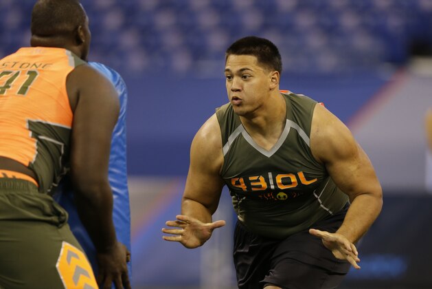 UCLA offensive lineman Xavier Su'A-Filo runs a drill at the NFL football scouting combine in Indianapolis, Saturday, Feb. 22, 2014. (AP Photo/Michael Conroy)