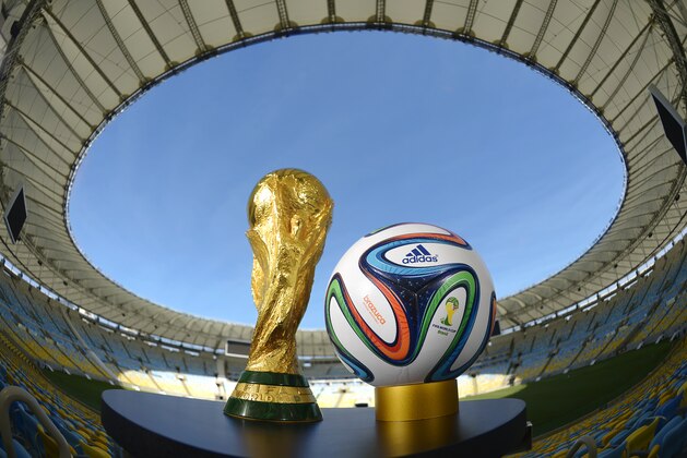 RIO DE JANEIRO, BRAZIL - DECEMBER 03:  A general view of Brazuca and the FIFA World Cup Trophy at the Maracana before the adidas Brazuca launch at Parque Lage on December 3, 2013 in Rio de Janeiro, Brazil. Brazuca is the Official Match Ball for the FIFA World Cup 2014 Brazil. Tonight adidas revealed brazuca to the world in the stunning setting of Parque Lage in Rio de Janeiro. The reveal was part of a spectacular light projection supported by global footballers Seedorf, Hernane and FIFA World Cup Winner Cafu. Hundreds of guests and celebrities were treated to this one off experience, which launched the Official FIFA World Cup Ball for Brazil 2014. For more information visit: news.adidas.com/worldcupOMB  (Photo by Alexandre Loureiro/Getty Images for adidas)