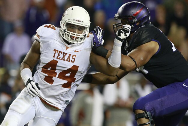Oct 26, 2013; Fort Worth, TX, USA; Texas Longhorns defensive end Jackson Jeffcoat (44) rushes the passer against TCU Horned Frogs offensive tackle Halapoulivaati Vaitai (74) in the third quarter of the game at Amon G. Carter Stadium. Mandatory Credit: Tim Heitman-USA TODAY Sports