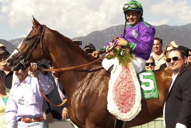 In a photo provided by Benoit Photo, California Chrome and jockey Victor Espinoza pose in the winner's circle after victory in the Santa Anita Derby horse race Saturday, April 5, 2014, at Santa Anita in Arcadia, Calif. (AP Photo/Benoit Photo)