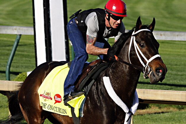Kentucky Derby hopeful Ride On Curlin gallops under exercise rider Bryan Beccia at Churchill Downs in Louisville, Ky., Saturday, April 26, 2014.  (AP Photo/Garry Jones)