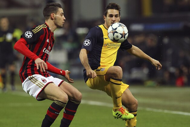 MILAN, ITALY - FEBRUARY 19:  Koke (R) of Club Atletico de Madrid competes for the ball with Mattia De Sciglio (L) of AC Milan during the UEFA Champions League Round of 16 match between AC Milan and Club Atletico de Madrid at Stadio Giuseppe Meazza on February 19, 2014 in Milan, Italy.  (Photo by Marco Luzzani/Getty Images)
