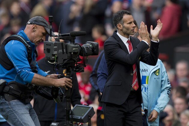 Manchester United's interim manager Ryan Giggs applauds supporters after his team's 4-0 win against Norwich City in their English Premier League soccer match at Old Trafford Stadium, Manchester, England, Saturday April 26, 2014. (AP Photo/Jon Super)