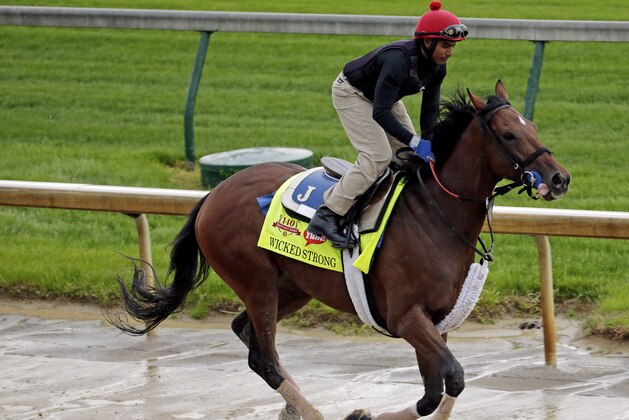 Exercise rider Kelvin Pahal takes Kentucky Derby hopeful Wicked Strong for a morning workout at Churchill Downs Monday, April 28, 2014, in Louisville, Ky. (AP Photo/Charlie Riedel)