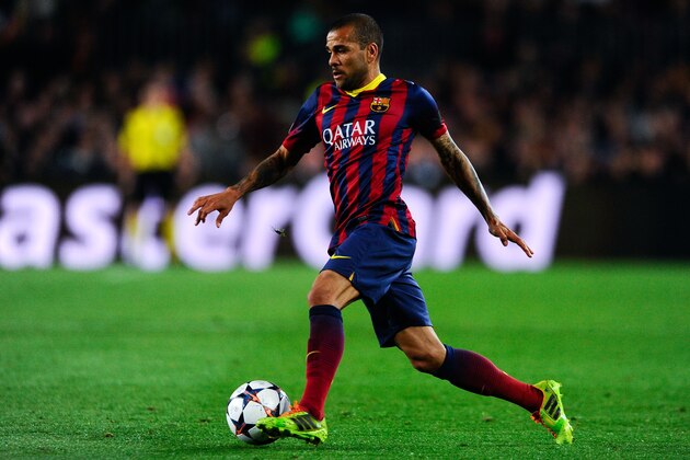 BARCELONA, SPAIN - MARCH 12:  Dani Alves of FC Barcelona runs with the ball during the UEFA Champions League Round of 16 second leg match between FC Barcelona and Manchester City at Camp Nou on March 12, 2014 in Barcelona, Spain.  (Photo by David Ramos/Getty Images)