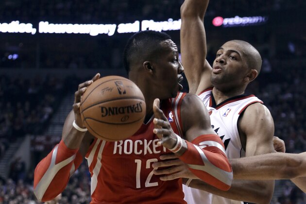 Houston Rockets center Dwight Howard, left, looks for an opening against Portland Trail Blazers forward Nicolas Batum during the first half of Game 3 of an NBA basketball first-round playoff series in Portland, Ore., Friday, April 25, 2014. (AP Photo/Don Ryan)